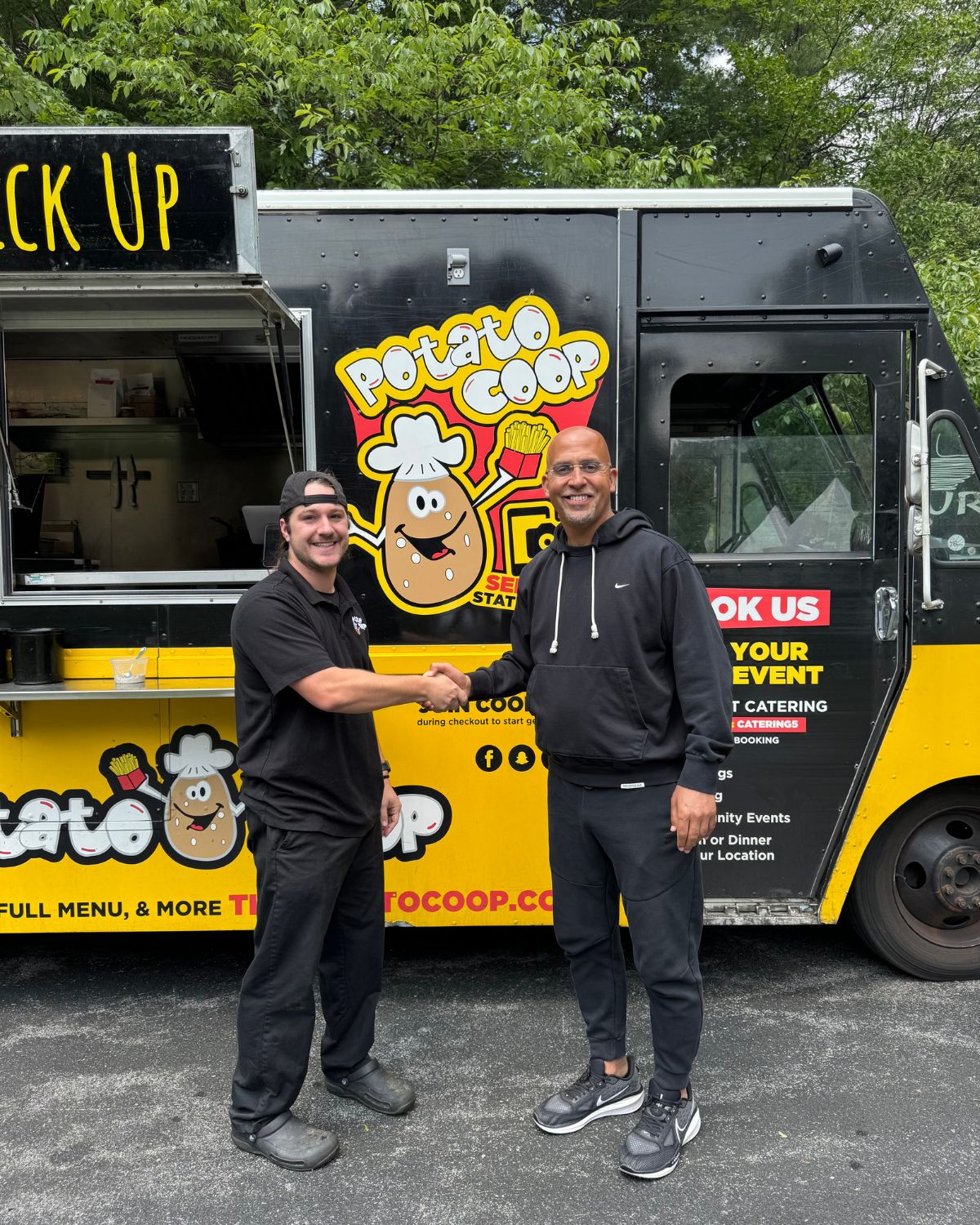 James Franklin shaking hands with a Potato Coop team member at the truck